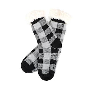 May include: A pair of black and white checkered slipper socks with a fuzzy white lining. The socks have grippy dots on the bottom.
