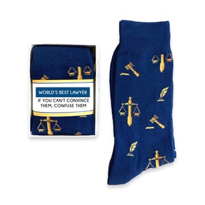 May include: A pair of blue socks with a gold pattern of scales of justice, gavel, and quill pens. The socks come in a box with a white label that reads "World's Best Lawyer If you can't convince them, confuse them."