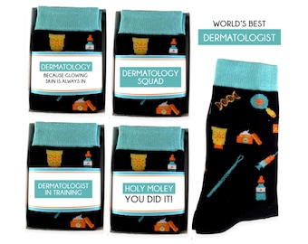 May include: Four pairs of black socks with colorful designs related to dermatology. The socks have a turquoise cuff and feature images of sunscreen bottles, face creams, magnifying glasses, and other dermatology-related items. The socks are packaged in boxes with labels that say "Dermatology Because Glowing Skin Is Always In", "Dermatology Squad", "Dermatologist In Training", and "Holy Moley You Did It!"
