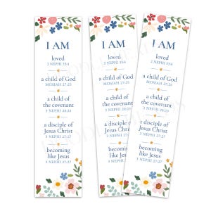 May include: Three white bookmarks with floral designs at the top and bottom. Each bookmark has the text "I AM" followed by inspirational phrases and scripture references in blue. The floral arrangements include red, pink, blue, and yellow flowers.