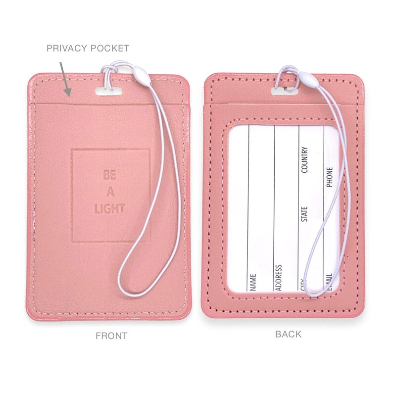 May include: A pink leather ID card holder with a white strap. The front has the text "BE A LIGHT" embossed in a square. The back has a clear window for an ID card and spaces to write name, address, city, state, country, email, and phone number.