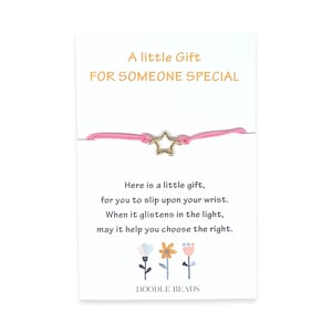 May include: A pink string bracelet with a gold star charm. The card reads "A little Gift FOR SOMEONE SPECIAL" and includes a poem about the bracelet. The card is decorated with three colorful flowers.