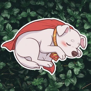 May include: A sticker of a white dog, asleep, wearing a red cape and a gold collar. The dog has a Superman logo on its chest. The background is a dark green leafy pattern.