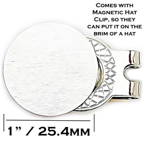 May include: A silver magnetic hat clip with a round, textured face, measuring 1 inch (25.4mm) in diameter. The clip has a unique design and the text "COMES WITH MAGNETIC HAT CLIP, SO THEY CAN PUT IT ON THE BRIM OF A HAT".