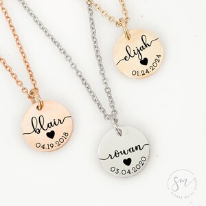 May include: Three silver necklaces with round pendants. Each pendant has a name and date engraved on it. The names are "Elijah", "Blair", and "Rowan".