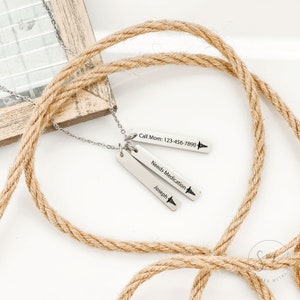 May include: Silver necklace with three rectangular tags. The top tag reads "Call Mom: 123-456-7890" with a small medical symbol. The middle tag reads "Needs Medication" with a small medical symbol. The bottom tag reads "Joseph" with a small medical symbol.