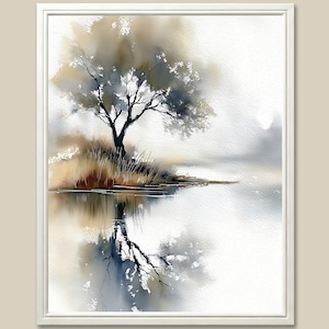 May include: A framed watercolor painting depicts a tree on a small island reflected in the water. The artwork features muted tones of gray, brown, and blue, creating a serene and atmospheric landscape scene. The painting is framed in a white border.