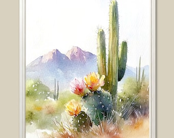 May include: Watercolor painting of a desert landscape featuring a tall green cactus with yellow and pink flowers. Mountains are in the background, with green and brown desert plants in the foreground. The artwork is framed in a white border.