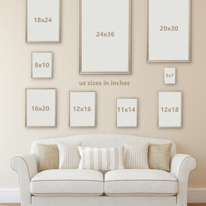 May include: A display of framed art prints in various sizes, including 18x24, 24x36, 20x30, 8x10, 5x7, 16x20, 12x16, 11x14, and 12x18 inches. The text "us sizes in inches" is visible. A white sofa with beige pillows is in the foreground.