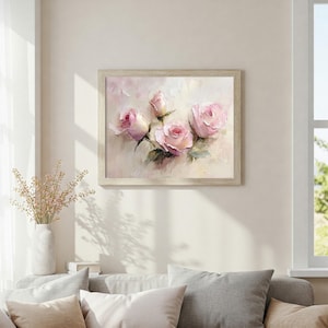 May include: A framed floral art print featuring a bouquet of pink roses. The painting has a soft, impressionistic style with visible brushstrokes. The roses are in various stages of bloom, set against a pale background, and framed in a light wood.