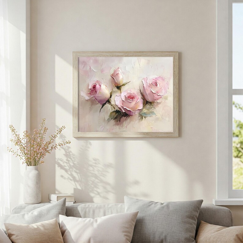May include: A framed floral art print featuring a bouquet of pink roses. The painting has a soft, impressionistic style with visible brushstrokes. The roses are in various stages of bloom, set against a pale background, and framed in a light wood.