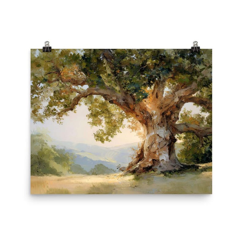 May include: A framed art print of a large, old oak tree with a textured, brown trunk and sprawling branches. The tree's green leaves are illuminated by sunlight, with a soft, blurred background of rolling hills and a golden field.