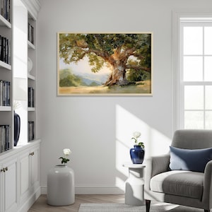 May include: A framed landscape painting depicts a large, old oak tree with a sprawling canopy of green leaves. The tree's trunk is textured and brown, set against a backdrop of rolling hills and a bright sky.