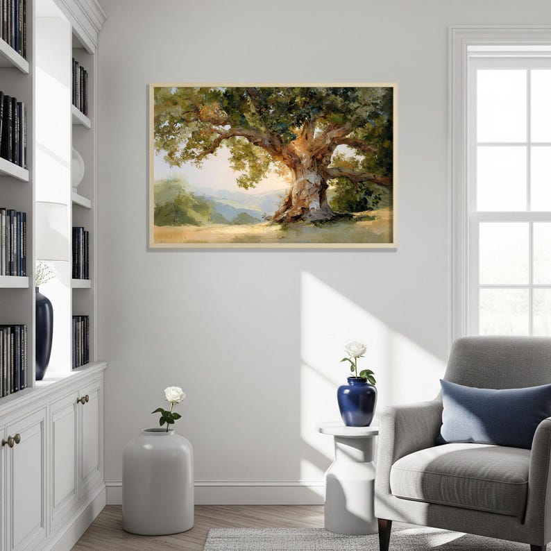 May include: A framed landscape painting depicts a large, old oak tree with a sprawling canopy of green leaves. The tree's trunk is textured and brown, set against a backdrop of rolling hills and a bright sky.