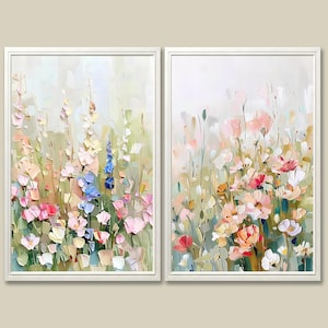 May include: A set of two vertical framed wall art prints featuring an abstract floral meadow scene. The paintings display thick, textured brushstrokes in shades of soft pink, muted green, cream, and accents of blue, depicting various wildflowers.