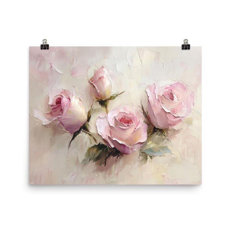 May include: A print of a floral painting featuring four pink roses in various stages of bloom. The roses have a soft, textured appearance with green leaves and stems against a light background. The artwork is attached to a white surface with black clips.