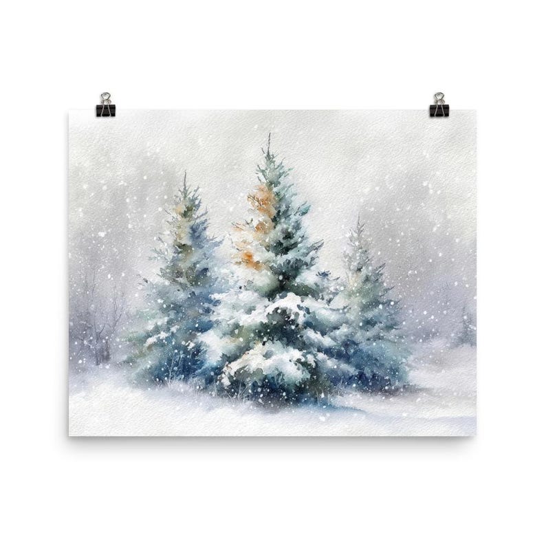 May include: Watercolor print of a winter scene featuring snow-covered evergreen trees. The artwork depicts a snowy landscape with falling snowflakes and a soft, muted color palette of blues, greens, and whites. The print is attached to a white background with a black clip.
