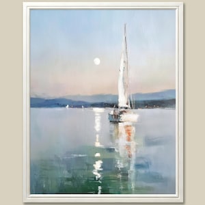 May include: Oil painting of a sailboat on a calm sea under a pale sky with a full moon. The artwork features a white sailboat with its sails up, reflecting in the water. Mountains are visible in the background, and the painting is framed in a white border.