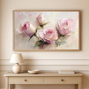 May include: A framed floral painting featuring five pink roses in various stages of bloom. The artwork has a textured, impressionistic style with a soft, neutral background. The roses are the focal point, with green leaves and stems.