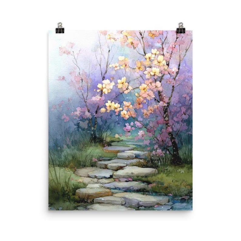 May include: Watercolor print of a serene garden path. The artwork features a stone pathway winding through a lush landscape with blooming trees in shades of pink and yellow. The background has a soft, dreamy quality with hues of blue and purple.