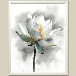 May include: Watercolor painting of a white lotus flower with yellow center and green-blue accents. The flower is set against a soft gray and white background, framed in a white border. The artwork captures the delicate beauty of the flower.