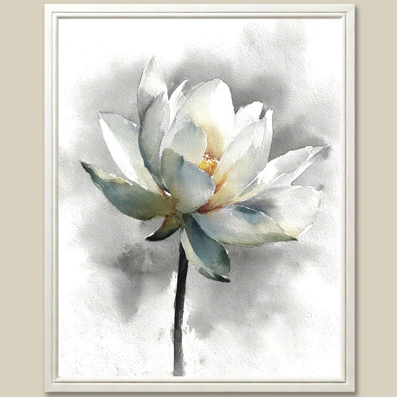 May include: Watercolor painting of a white lotus flower with yellow center and green-blue accents. The flower is set against a soft gray and white background, framed in a white border. The artwork captures the delicate beauty of the flower.