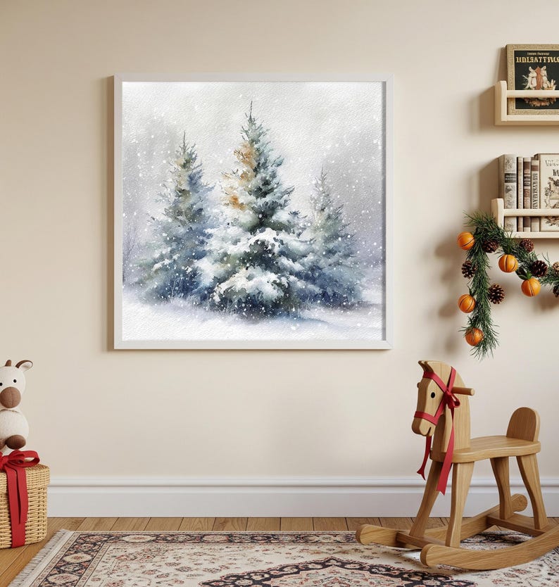 May include: A framed watercolor painting depicts a snowy winter scene with evergreen trees. The artwork features a soft, muted color palette of blues, whites, and touches of gold, evoking a serene, wintry atmosphere. The painting is displayed on a light-colored wall.