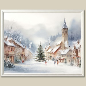 May include: Watercolor painting of a snow-covered village scene. Buildings with red-tiled roofs and a tall church tower are visible. A Christmas tree stands in the center, and figures walk in the snow. The artwork is framed in a white border.