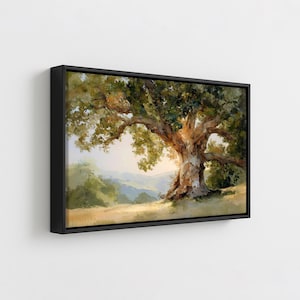 May include: A framed canvas print of a large oak tree in a field. The tree has a thick, textured trunk and sprawling branches with green leaves. The background features rolling hills and a soft, light-filled sky. The frame is black.