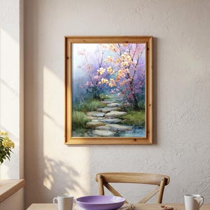 May include: A framed watercolor painting depicts a stone path winding through a serene garden. The path is flanked by lush greenery and flowering trees with pink and yellow blossoms. The artwork is encased in a light brown wooden frame.