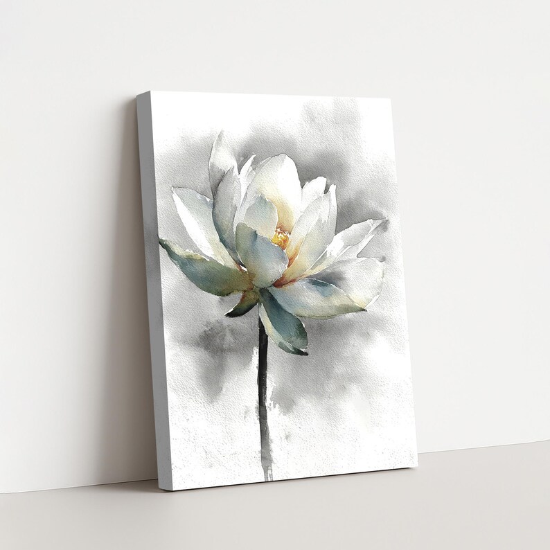 May include: A canvas print featuring a watercolor painting of a white lotus flower. The flower has delicate petals with hints of blue and yellow, set against a soft gray and white background. The stem is a dark gray.