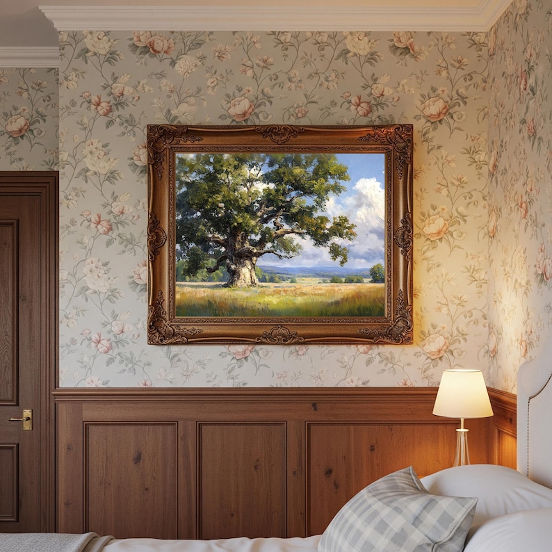 May include: A framed landscape painting of a large tree in a field under a cloudy sky. The painting has a gold ornate frame and is hanging on a floral wallpapered wall. The room has wood panelling and a lamp.
