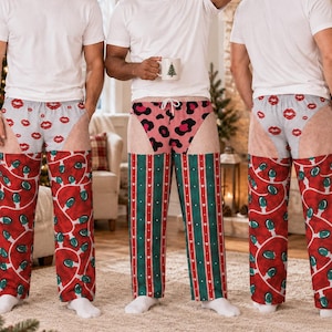 May include: Three white crew neck t-shirts paired with novelty pajama pants. The pants feature a faux-skin tone upper section with various prints including red lips, pink leopard spots, and red and green Christmas light patterns.