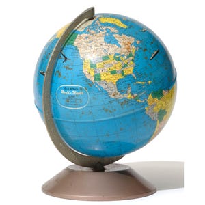 May include: A vintage Rand McNally World-Master globe with a blue ocean and colorful continents. The globe has a metal base and a gray meridian ring. The globe shows North America and has small airplane illustrations.