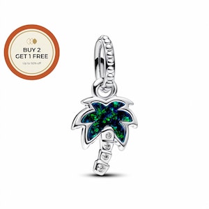 May include: A silver charm shaped like a palm tree. The palm fronds are filled with a dark green and blue iridescent material. The trunk has three clear, round stones. The charm has a loop for attaching to a bracelet or necklace.