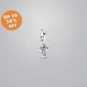May include: A silver cross charm with embedded clear gemstones, suspended from a curved loop. The charm is displayed against a grey background. An orange circle with the text "UP TO 50% OFF" is in the upper left corner.