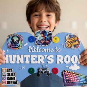 May include: A light blue, controller-shaped sign with the text "Welcome to Hunter's Room" in white pixelated letters. The sign features gaming-themed graphics, including a headset, a gamer, and a keyboard. The sign also includes the text "Eat, Sleep, Game, Repeat."