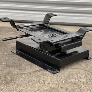 May include: Black metal swivel seat base with a lever for adjusting the seat height. The base is designed for use with a car seat.