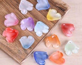 May include: A collection of translucent, petal-shaped beads in various colors, including red, blue, purple, and yellow. Each bead has a small hole for stringing and is displayed on a wooden surface. These beads are suitable for jewelry making.