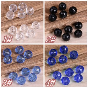 May include: Four sets of faceted glass beads in different colors. The first set is clear, the second is black, the third is light blue, and the fourth is dark blue.