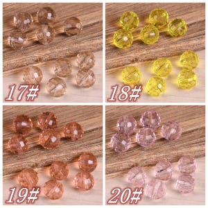 May include: Four sets of faceted glass beads in different colors: clear, yellow, orange, and pink. Each set is labeled with a number: 17#, 18#, 19#, and 20#.