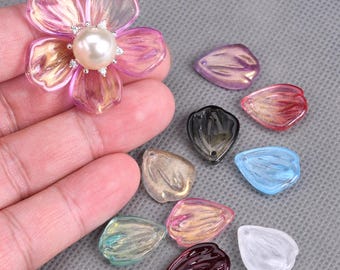 May include: Assortment of colorful plastic flower petals in various shapes and sizes. The petals are translucent and have a glossy finish.