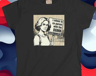 May include: Black t-shirt featuring a graphic of a woman holding a sign that reads "I refuse to co-parent with the DAMN GOVERNMENT." The image is in black and white with a vintage comic book style.