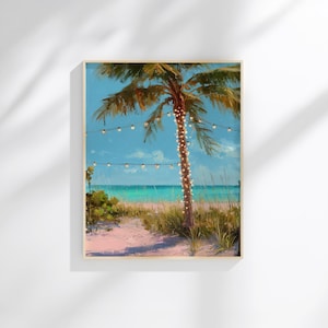 May include: A framed painting depicting a tropical beach. A palm tree is adorned with fairy lights, and the beach features pink sand. The ocean is turquoise, and the sky is a bright blue with a few clouds. The painting is in a light wood frame.