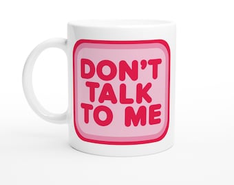 May include: White ceramic mug with a pink square design. The square has a red outline and the text "DON'T TALK TO ME" in red.