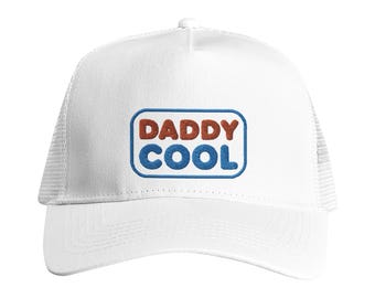 May include: White trucker cap with a mesh back and a curved peak. The front displays the text "DADDY COOL" in brown and blue embroidery, framed by a blue rectangle. A casual hat.