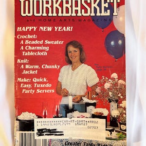 May include: The Workbasket magazine cover from January 1987 features a red background with the title in white and black. The cover includes a woman wearing a white crocheted top, balloons, and text promoting crochet and knit projects.