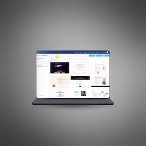 May include: A laptop computer displaying a website interface with various design templates. The screen shows multiple layouts with text and images, including a "Thank You" page. The laptop is on a gray surface.