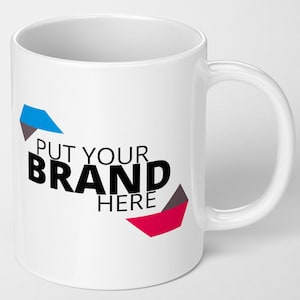 May include: White ceramic mug with a curved handle. The mug features the text "PUT YOUR BRAND HERE" in black, with blue, red, and grey geometric shapes. The mug is designed for beverages.