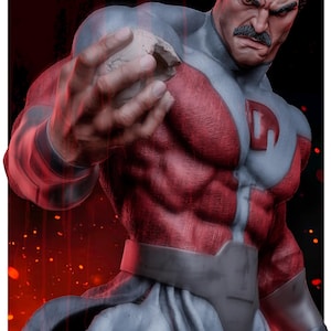 May include: A muscular action figure with a dark mustache, wearing a red and grey suit with a prominent letter G on the chest. The figure has a stern facial expression and is holding a small, light-colored rock-like object in one hand.